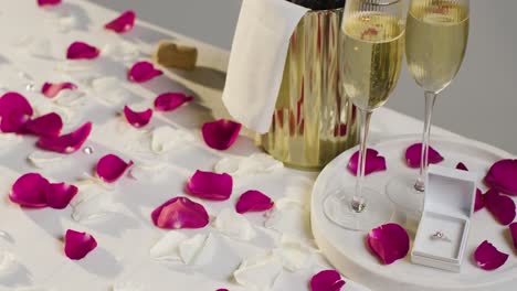 Table-Set-For-Romantic-Marriage-Proposal-With-Champagne-And-Engagement-Ring